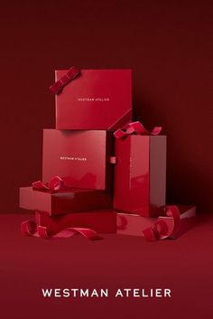 red boxes with bows are stacked on top of each other and the words westman atelier