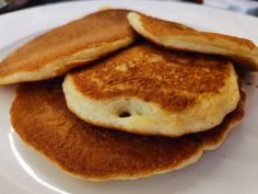 three pancakes sitting on top of a white plate