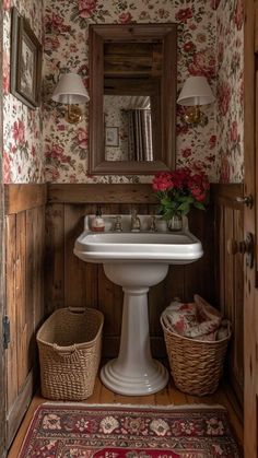 a white pedestal sink sitting under a mirror in a bathroom next to a wooden door