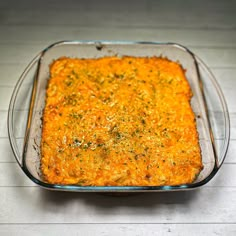 a casserole dish with cheese and herbs in it