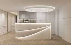 the interior of a modern office with white walls and wood flooring is lit by recessed lighting