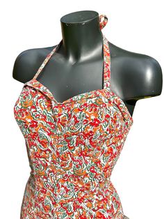 Here we have an original 1950s one-piece bathing suit in fabulous oranges & reds. The front is smooth in style with a little flat 'skirt' across the bottom. The back is entirely ruched. The swimming costume is lined throughout the front and crotch in white cotton. Halter 'tie' neck. Boning in the bra. No makers label... just the remnants of a size label. Sizing.... The mannequin it was photographed on is a  36" bust, 28" waist and 37" hip... The cups look as though they would fit a 'B' cup or ev Fitted Retro Swimwear For Pool, Retro Fitted Lined Swimwear, Fitted Retro Print Swimwear For Beach, Fitted Retro Print Beachwear Swimwear, Retro Fitted Swimwear For Poolside, Retro Fitted Summer Tankini, Fitted Orange One-piece Swimwear, Retro Lined Swimwear For Summer, Retro Summer Swimwear Lined