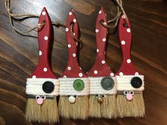 three red and white christmas decorations with buttons on them