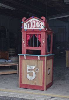 an old fashioned ticket booth with the number five on it