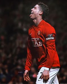 a man in red shirt and white shorts with his mouth open while standing on a soccer field