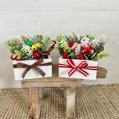 two small white boxes with christmas decorations on them