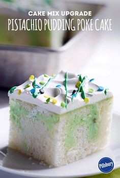 a piece of cake on a white plate with green and yellow sprinkles