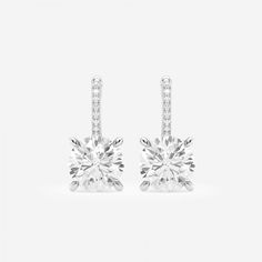 Badgley Mischka has always been the epitome of old Hollywood glamor, and nothing speaks to it more than these drop earrings. Round diamonds set in a classic four prong setting, dangle elegantly from a diamond studded lever back. Elegant Evening Diamond Earrings With Vvs Clarity, Elegant Diamond Earrings With Vvs Clarity For Evening, Classic Diamond Cut Bridal Earrings For Evening, Dazzling Pave Setting Wedding Earrings, White Diamond Earrings With Prong Setting For Evening, Bridal Platinum Drop Earrings With Prong Setting, Formal Bridal Earrings With Pave Setting, Platinum Bridal Drop Earrings With Prong Setting, Refined Diamond Earrings For Formal Occasions