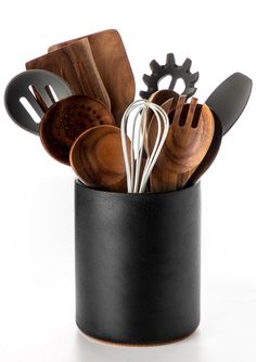 wooden utensils and spoons in a black cup