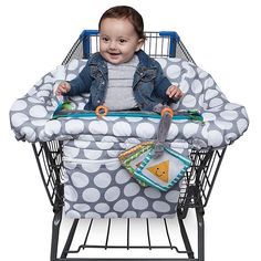 a baby is sitting in a shopping cart