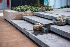 two rocks sitting on top of cement steps