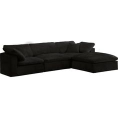 a black sectional couch with pillows on it's back and the seat folded out