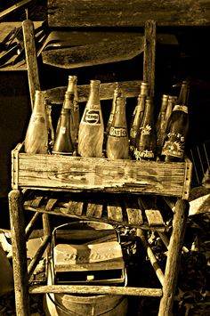 an old wooden chair with bottles on it