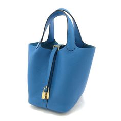 Hermes Handbag Picotin Lock Pm Taurillon Clemence Blue Zanzibar Gold Hardware Approx. 18cm Wide X 19cm Long X 13.5cm Deep / Handle Length: Approx. 30cm Box, Storage Bag, Padlock, Key Designer Blue Rectangular Bucket Bag, Luxury Blue Bucket Bag For Daily Use, Luxury Blue Bucket Bag For Shopping, Blue Bucket Bag With Gold-tone Hardware, Chic Blue Bucket Bag With Gold-tone Hardware, Blue Travel Bucket Bag With Gold-tone Hardware, Luxury Blue Bucket Bag For Travel, Luxury Blue Bucket Bag With Gold-tone Hardware, Elegant Blue Bucket Bag With Gold-tone Hardware