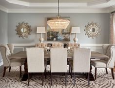 a dining room table with chairs and a chandelier