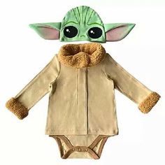 a baby yoda doll is wearing a brown jacket and tan onesuit with fur collar