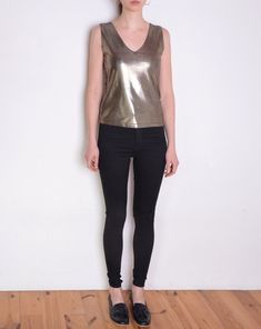 Cool vintage blouse made of unique fabric: shiny metallic textile in color that looks like a mix of silver and gold. Texture of tiny dots on almost invisible black background. Sleeveless, v neckline. Era: 90's, brand Hennes Fabric: 80% polyamide, 20% elasthane Condition: very good Estimated size: M / L (please, check the measurements) Measurements (measured flat, without stretching. Item is stretchy. Need to be doubled to get the circumference.): Chest: 42 cm / 16,5 inches Length: 55 cm / 21,6 i Glamorous Metallic Shimmer Tops, Metallic Shiny Top For Party Season, V-neck Shimmer Tops For Party Season, Chic Metallic Tops With Shine Detail, Chic Metallic Shine Tops, Chic Fitted Metallic Tank Top, Glamorous Fitted Tops With Sheen, Glamorous Fitted Shiny Blouse, Glamorous Shiny Gold Tops