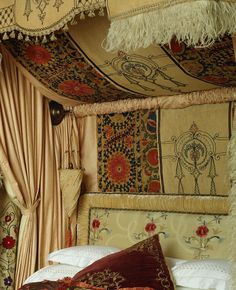 a bed with an elaborate headboard and pillows