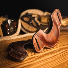 a pair of leather shoes sitting on top of a wooden table