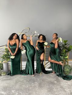 four women in green dresses posing for the camera