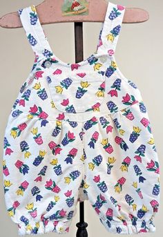 Vintage 90s CIRCO Floral Flower Pot Sleeveless Bubble Romper Baby Girls Sz 12mo Excellent Vintage Condition. Sold as Pictured. Adorable Vintage 1990's 1980's Oshkosh B'Gosh Baby vibes. Pattern of tulips in pink, purple, and yellow in coordinating flower pots. Tag says Size 12 Months. Please refer to measurements to ensure fit. Measurements: Pit to Pit 10". Shoulder to Saddle 15". Follow us at Coppertop_Vintage. Casual Sleeveless Floral Print Bubble Romper, Multicolor Sleeveless Bubble Romper For Spring, Pink Floral Print Sleeveless Bubble Romper, Playful Sleeveless Bubble Romper With Floral Print, Sleeveless Floral Print Bubble Romper, Multicolor Floral Print Cotton Bubble Romper, Multicolor Cotton Floral Print Bubble Romper, Girls Overalls, 90s Baby