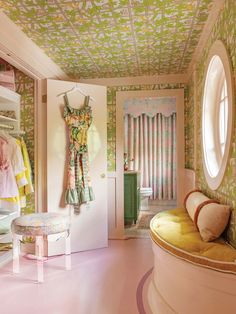 a room with pink flooring and green wallpaper on the ceiling is decorated in pastel colors