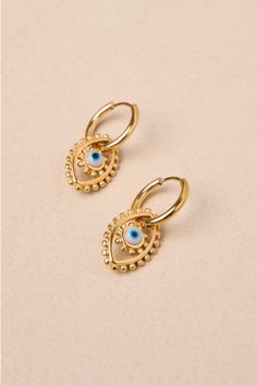 Bring a lucky vibe to all your outfits with the help of the Petit Moments Eye Time Gold Evil Eye Charm Huggie Hoop Earrings! Shiny, gold-toned metal shapes these striking earrings that have small, hinged huggie-style silhouettes that support evil eye charms with circular blue pupils and dot-like raised edges. Hinged post backs. Earrings measure 1" long. 95% Stainless Steel, 5% Glass. Imported. Lulus | Eye Time Gold Evil Eye Charm Huggie Hoop Earrings. Gold-tone Gold-plated Nickel-free Hoop Earrings, Nickel-free Gold Metal Huggie Earrings, Gold Metal Huggie Cartilage Earrings, Nickel-free Teardrop Gold Plated Hoop Earrings, Gold Teardrop Nickel-free Cartilage Earrings, Dainty Metal Nickel-free Huggie Earrings, Dainty Metal Pierced Hoop Earrings, Nickel-free Dainty Metal Hoop Earrings, Wedding Top