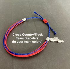 a red, white and blue bracelet with the words cross country track team bracelets in your team colors