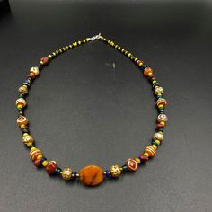 The Beautiful Necklace Consist Of Ancient Glass Beads ,Beautiful Luk Mik Or Magic Eye Agate and Etched Carnelian Agate From Indo Himalaya Some Gold Plated Wax Beads and Some Gold Color Brass Beads Are Used As Spacers Traditional Yellow Gemstone Beads Necklace, Amber Agate Beaded Necklace With Colorful Beads, Multicolor Carnelian Jewelry With Large Beads, Traditional Multicolor Carnelian Necklaces, Handmade Multicolor Carnelian Beads, Gems, And Cabochons, Multicolor Large Beads Agate Necklace, Multicolor Carnelian Beaded Necklace With Large Beads, Multicolor Carnelian Necklaces With Polished Beads, Multicolor Carnelian Beaded Necklaces With Large Beads