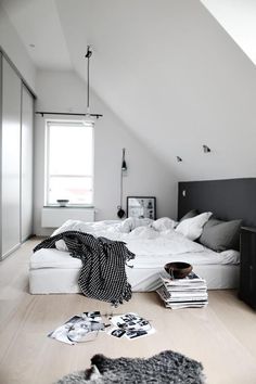 a bed sitting in the middle of a bedroom next to a window