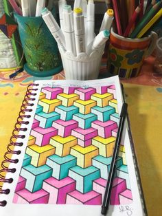 an open notebook with markers and pencils on it