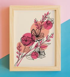 an art print with pink and black flowers in a wooden frame on a multicolored background