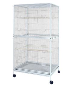 a large white bird cage on wheels with two shelves and one door open to the other side