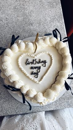 a heart shaped birthday cake with writing on it