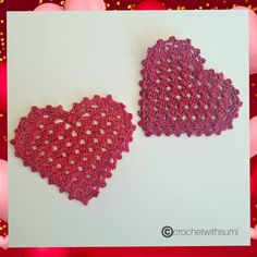 two crocheted hearts sitting next to each other