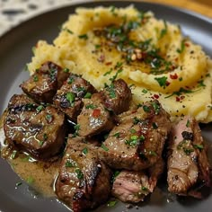 a plate with meat, mashed potatoes and gravy