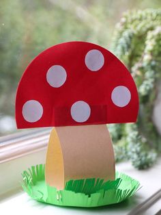 a paper mushroom sitting on top of a window sill