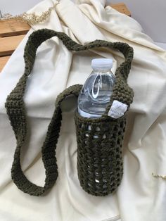 a crocheted bag with a water bottle in it