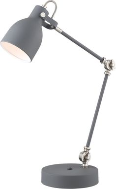 the grey desk lamp is on top of a round base and has an adjustable arm