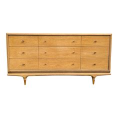 a wooden dresser with six drawers on one side and two legs at the other end