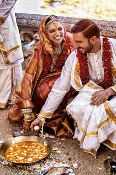 a man and woman sitting next to each other on the ground