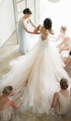 the bride is getting ready to walk down the aisle in her wedding dress with her bridal party