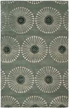 a rug with an intricate design on the front and back of it, in grey