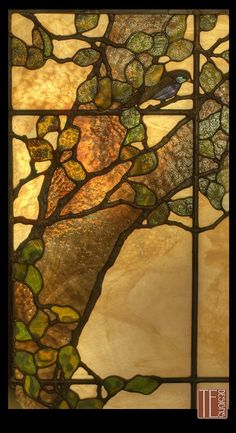 a stained glass window with leaves on it