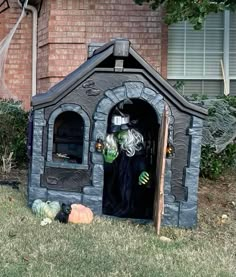 an outdoor halloween house with a witch in it