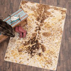 a brown and white area rug sitting on top of a wooden floor