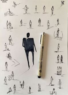 a pen is sitting on top of a paper with drawings of people and bikes in the background