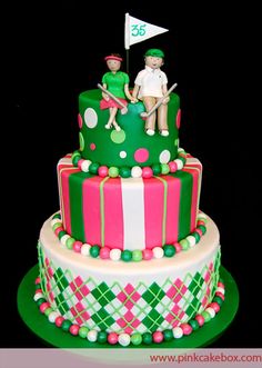 a three tiered cake with two people on top and one holding a golf flag