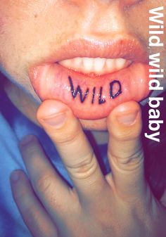 a woman with her tongue out and the word wild written on it's lip