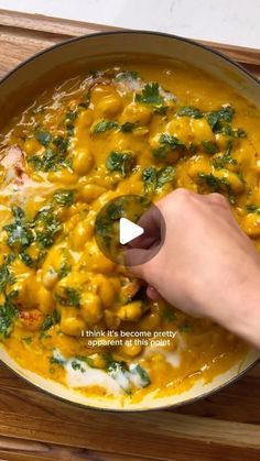 a person is stirring some food in a pan